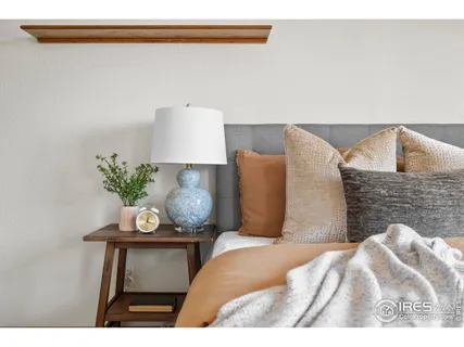 a bedroom with a bed and a potted plant