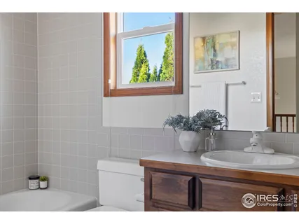 a bathroom with a granite countertop sink a mirror and vanity