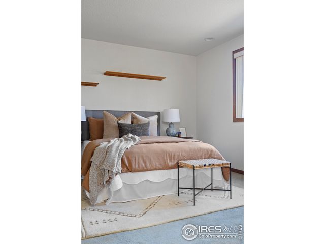 a bedroom with a bed and a wall painting