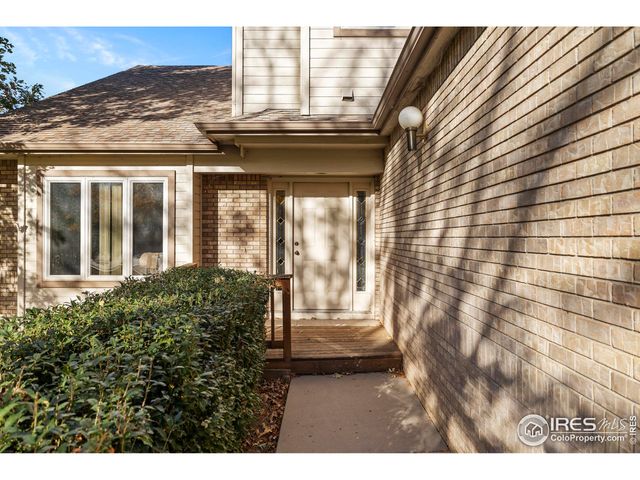 a view of a porch with furniture and floor to ceiling window