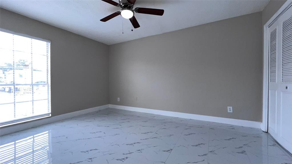 305 Wymore Road, Unit 203 Altamonte Springs, FL 32714 - Photo 12 of 21 an empty room with a window and a fan