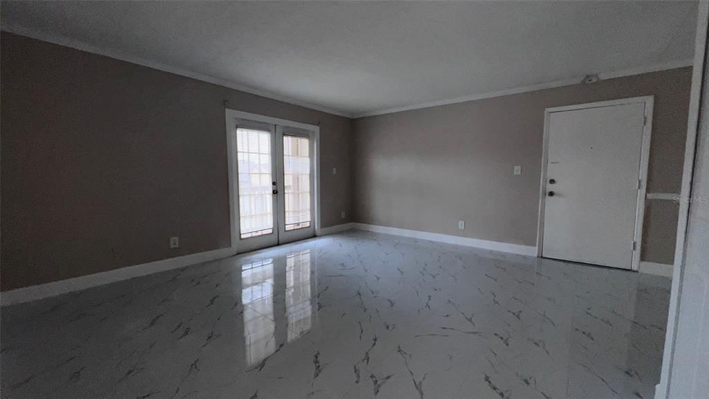 305 Wymore Road, Unit 203 Altamonte Springs, FL 32714 - Photo 19 of 21 an empty room with wooden floor and windows