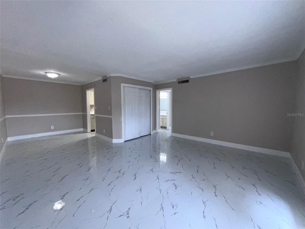 305 Wymore Road, Unit 203 Altamonte Springs, FL 32714 - Photo 4 of 21 an empty room with wooden floor and windows