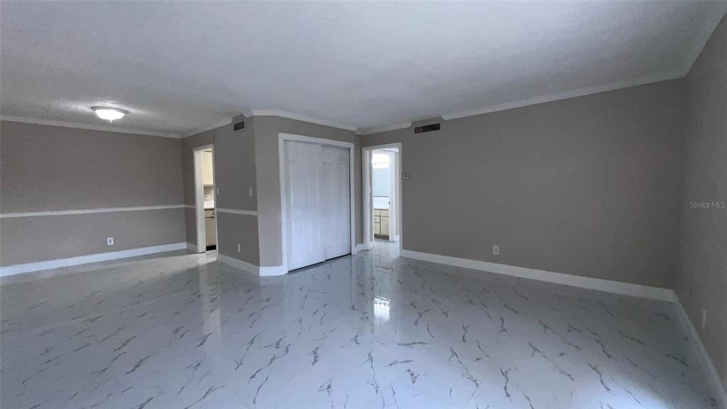 305 Wymore Road, Unit 203 Altamonte Springs, FL 32714 - Photo 5 of 21 a view of an empty room with wooden floor closet and windows