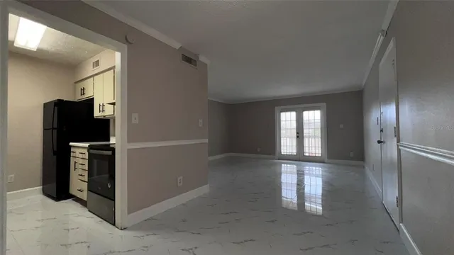 a view of livingroom with an empty space and a window