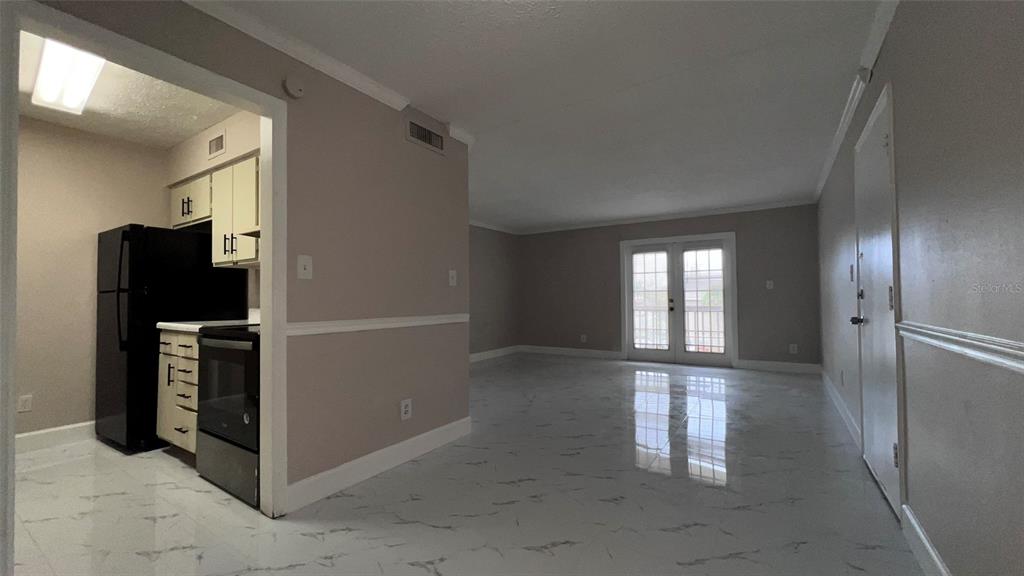 305 Wymore Road, Unit 203 Altamonte Springs, FL 32714 - Photo 6 of 21 a view of livingroom with an empty space and a window