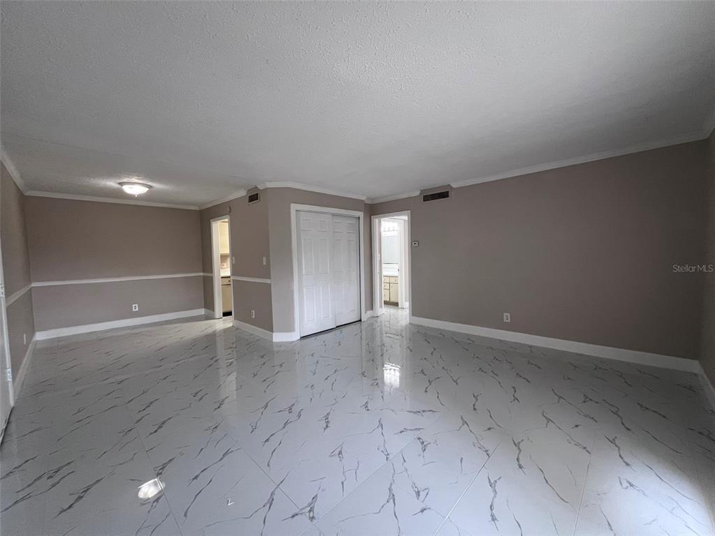 305 Wymore Road, Unit 203 Altamonte Springs, FL 32714 - Photo 7 of 21 an empty room with wooden floor and windows