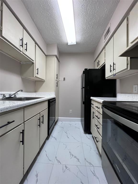 305 Wymore Road, Unit 203 Altamonte Springs, FL 32714 - Photo 8 of 21 a kitchen with stainless steel appliances a refrigerator and a stove