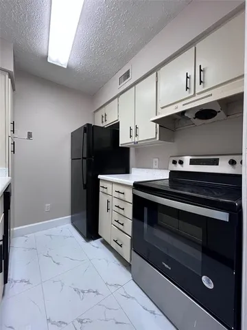 a kitchen with stainless steel appliances a stove a microwave and cabinets