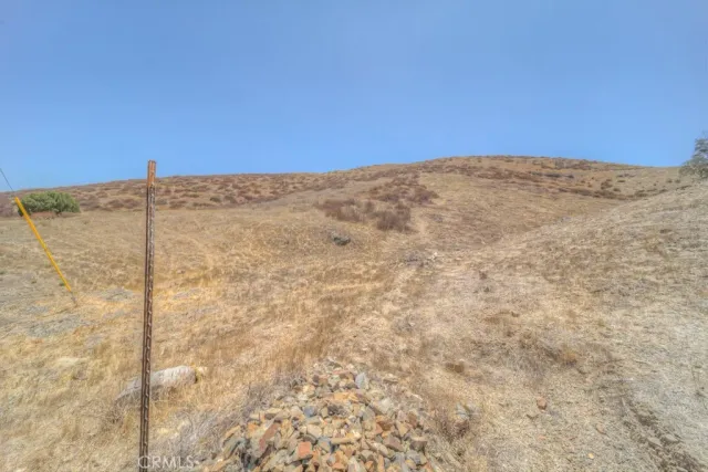 a view of a dry yard with mountain view