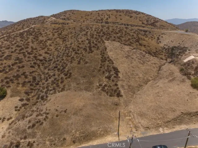 a large stone house with a mountain in the background
