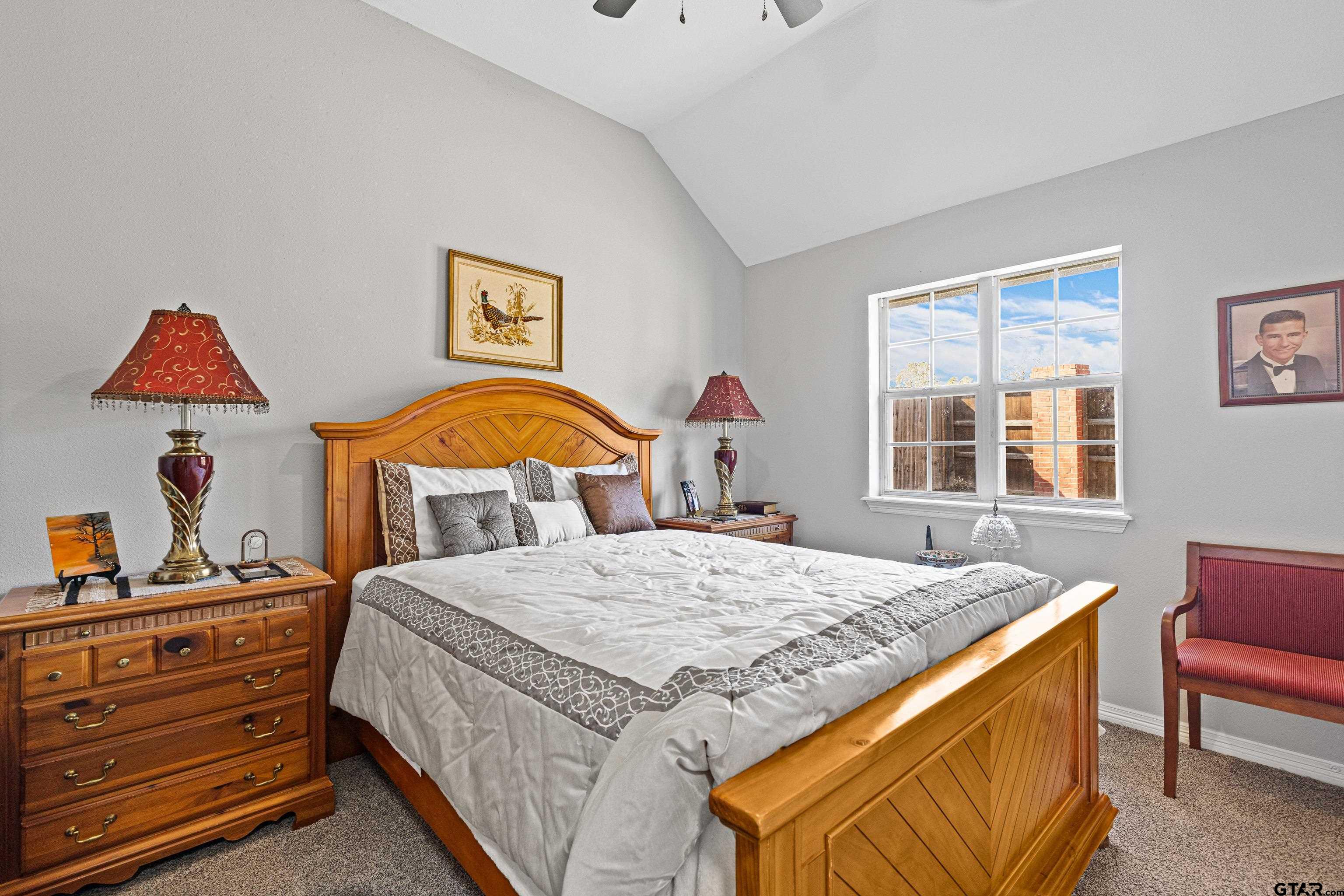 102 Fairway Street Chandler, TX 75758 - Photo 17 of 33 a bedroom with a bed and dresser with mirror