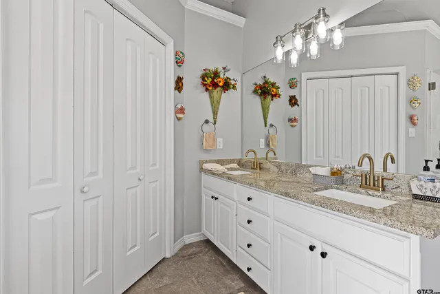 a bathroom with a granite countertop sink two mirror and a