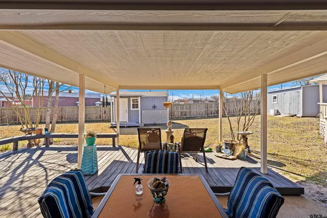 a view of a dining room with furniture water view and wooden floor