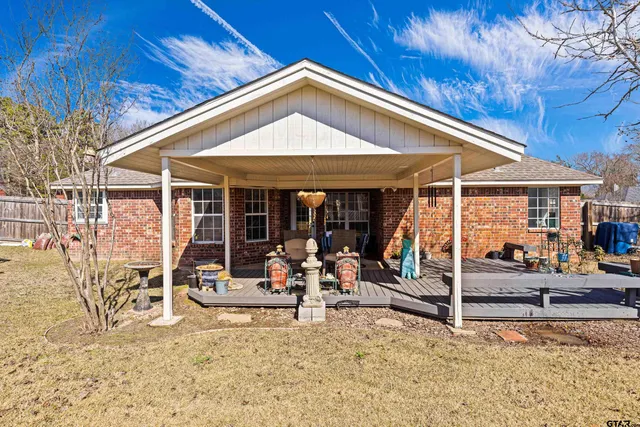 a view of a house with backyard porch and sitting area