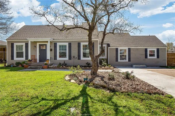 a front view of house with yard and green space