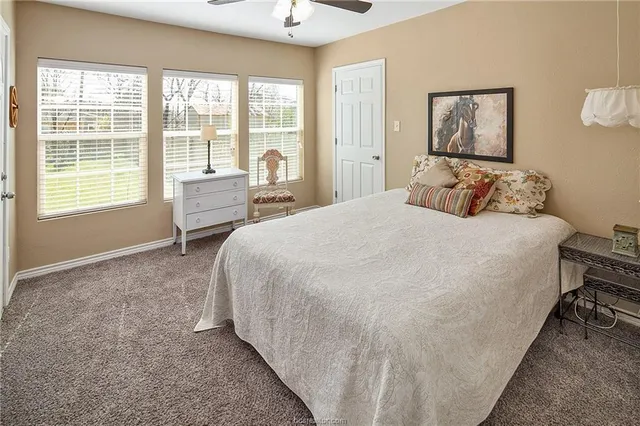 a bed room with a bed and a chair