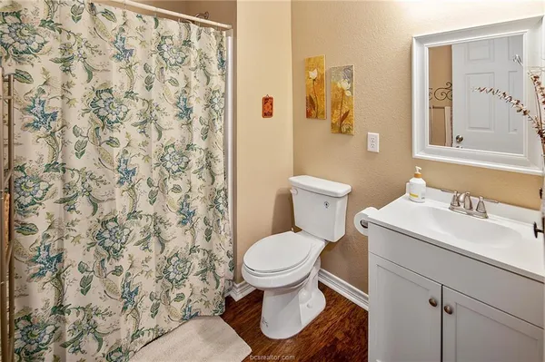 a white toilet sitting next to a bathroom sink