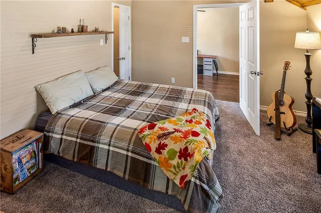 a bedroom with a bed and a table in it