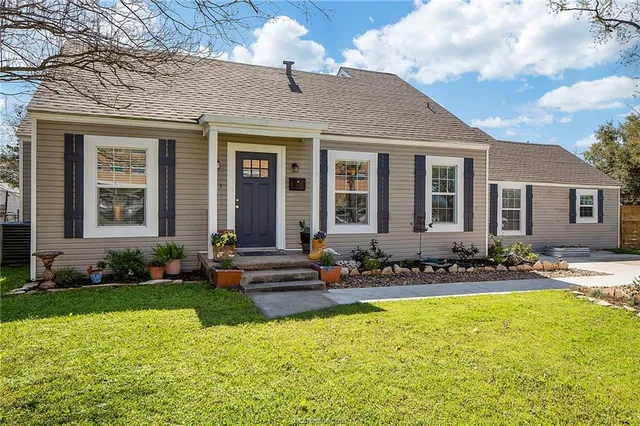 a front view of a house with a yard table and chairs