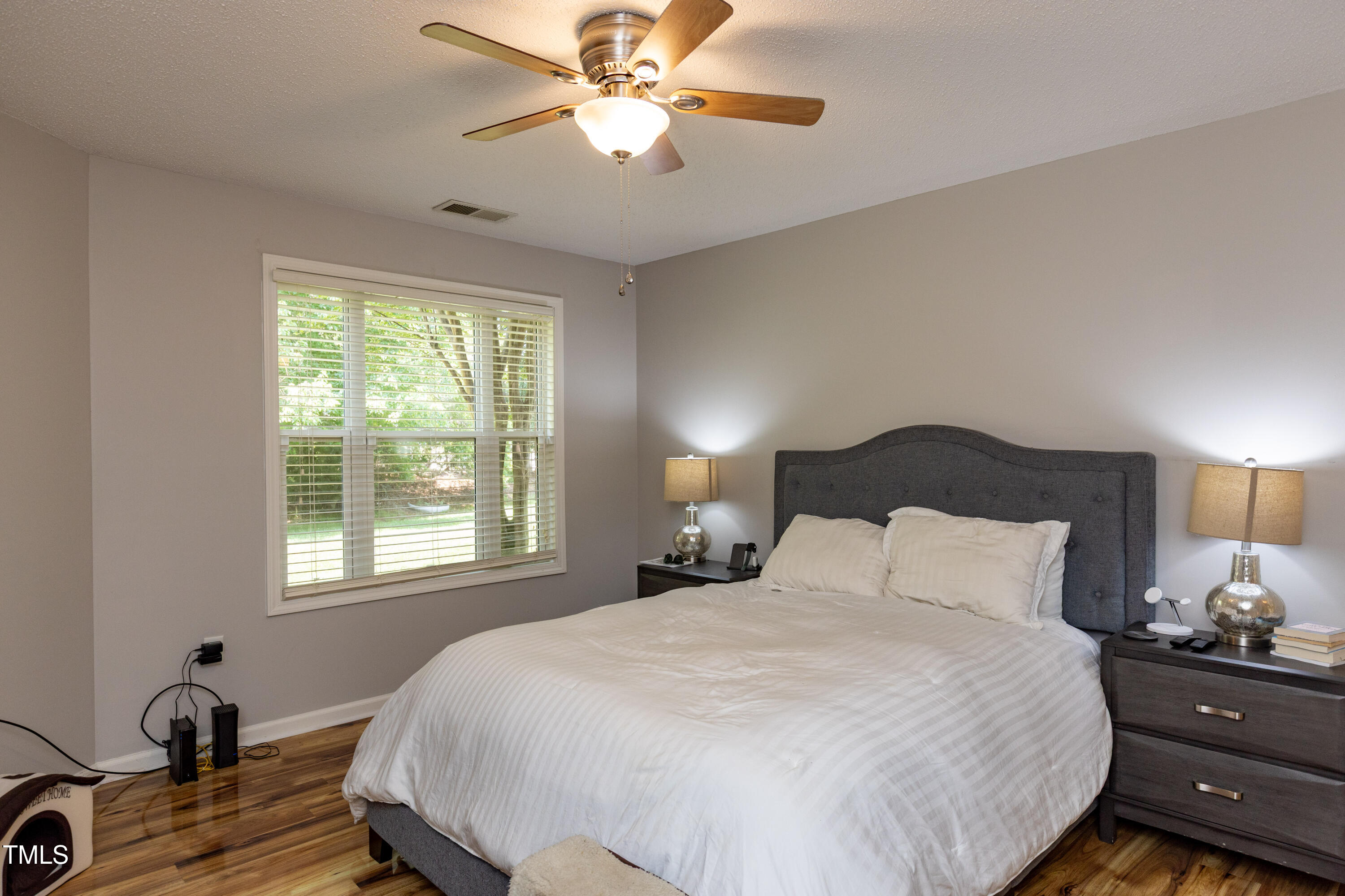 1911 Falls Landing Drive, Unit 103 Raleigh, NC 27614 - Photo 12 of 28 a bedroom with a bed and a window