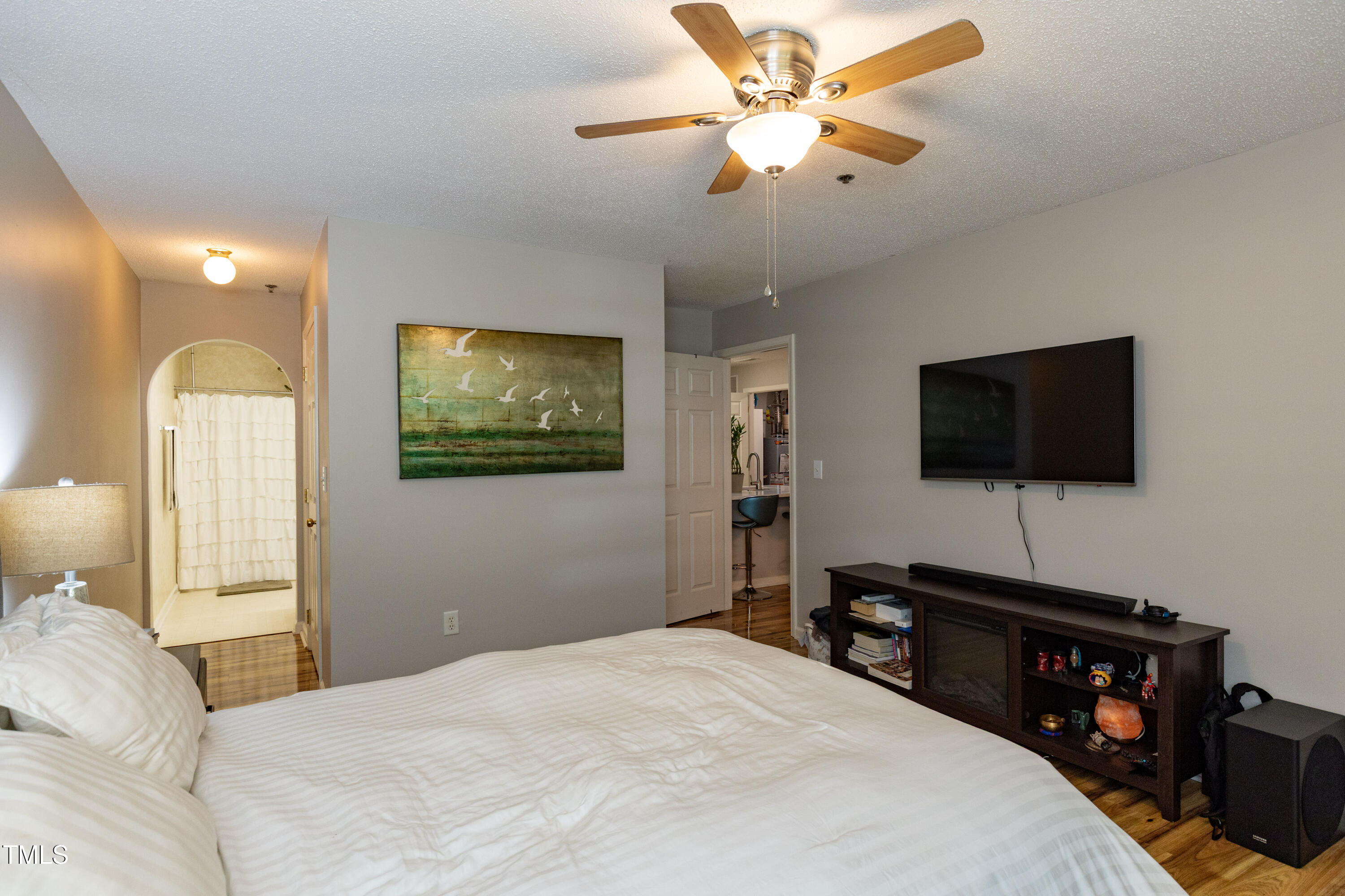 1911 Falls Landing Drive, Unit 103 Raleigh, NC 27614 - Photo 13 of 28 a bedroom with a bed and a flat screen tv