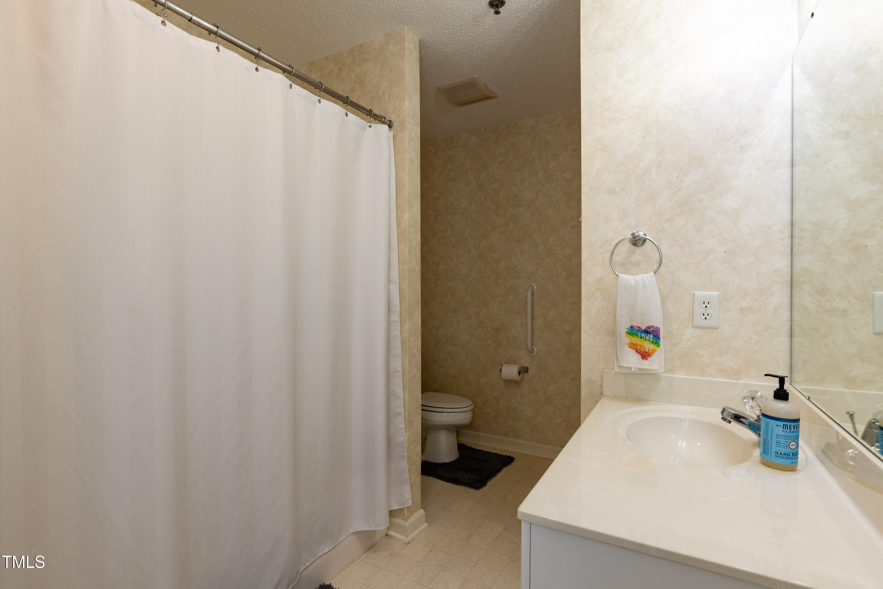 1911 Falls Landing Drive, Unit 103 Raleigh, NC 27614 - Photo 20 of 28 a bathroom with a sink and a mirror