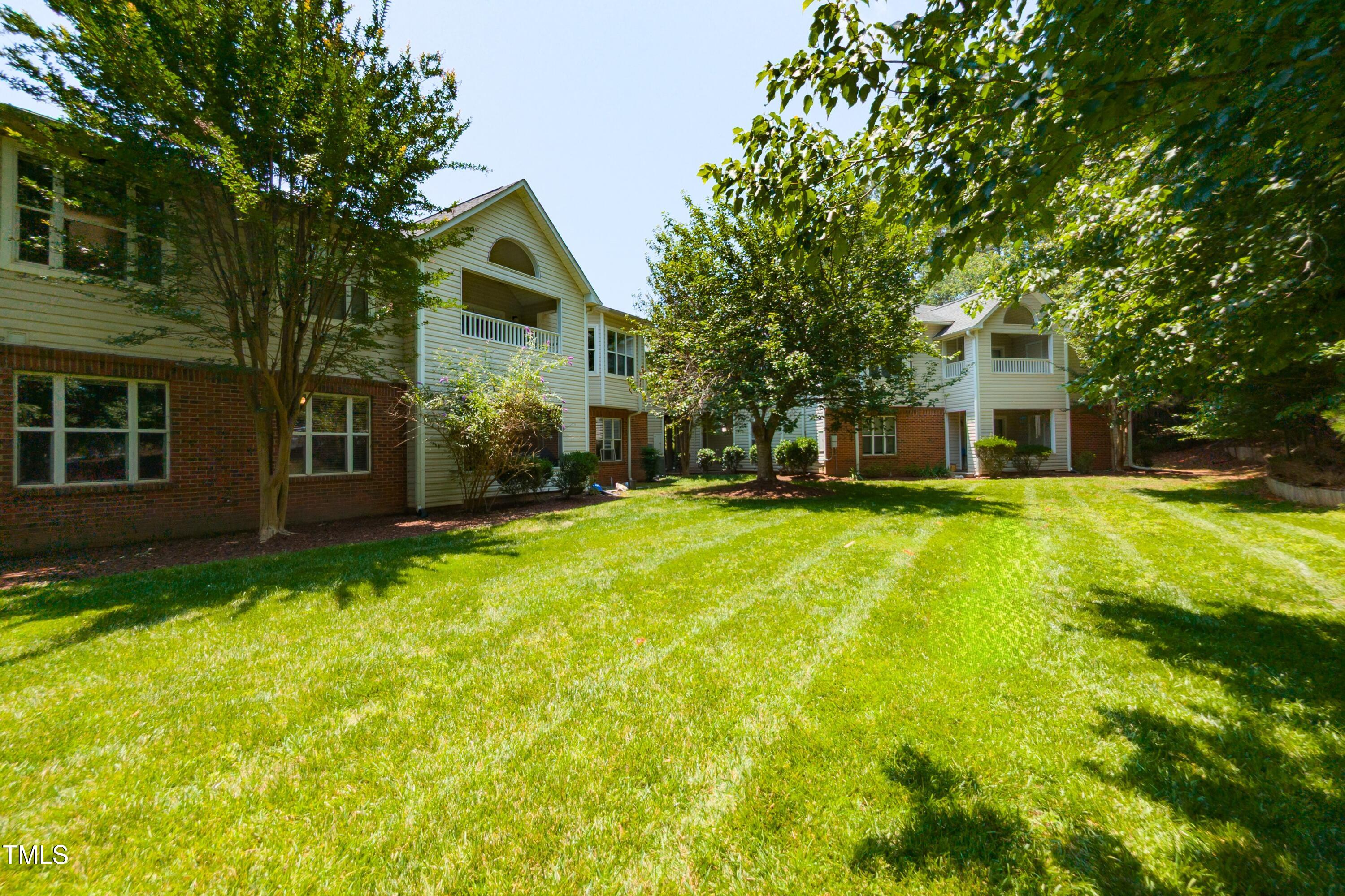 1911 Falls Landing Drive, Unit 103 Raleigh, NC 27614 - Photo 25 of 28 a front view of a house with a yard