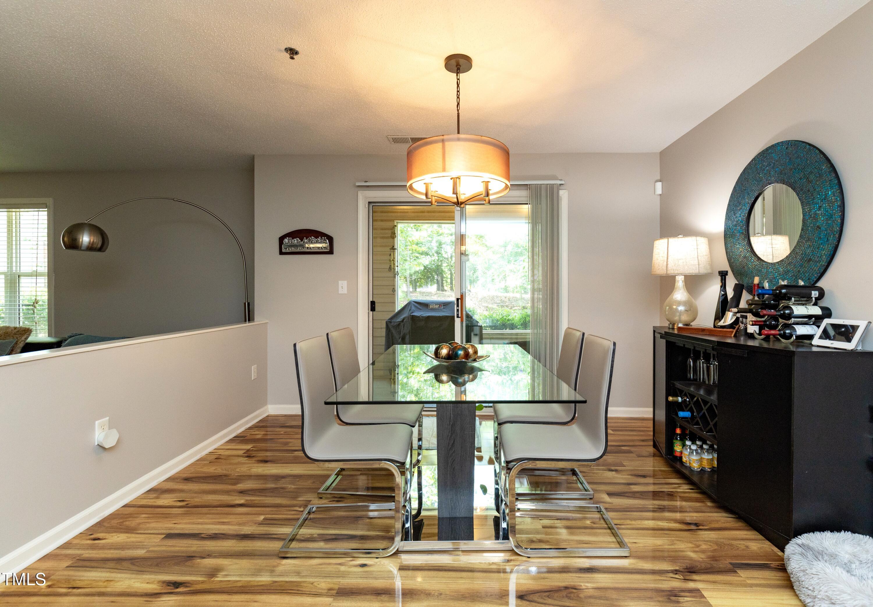 1911 Falls Landing Drive, Unit 103 Raleigh, NC 27614 - Photo 7 of 28 a view of a dining room with furniture window and wooden floor
