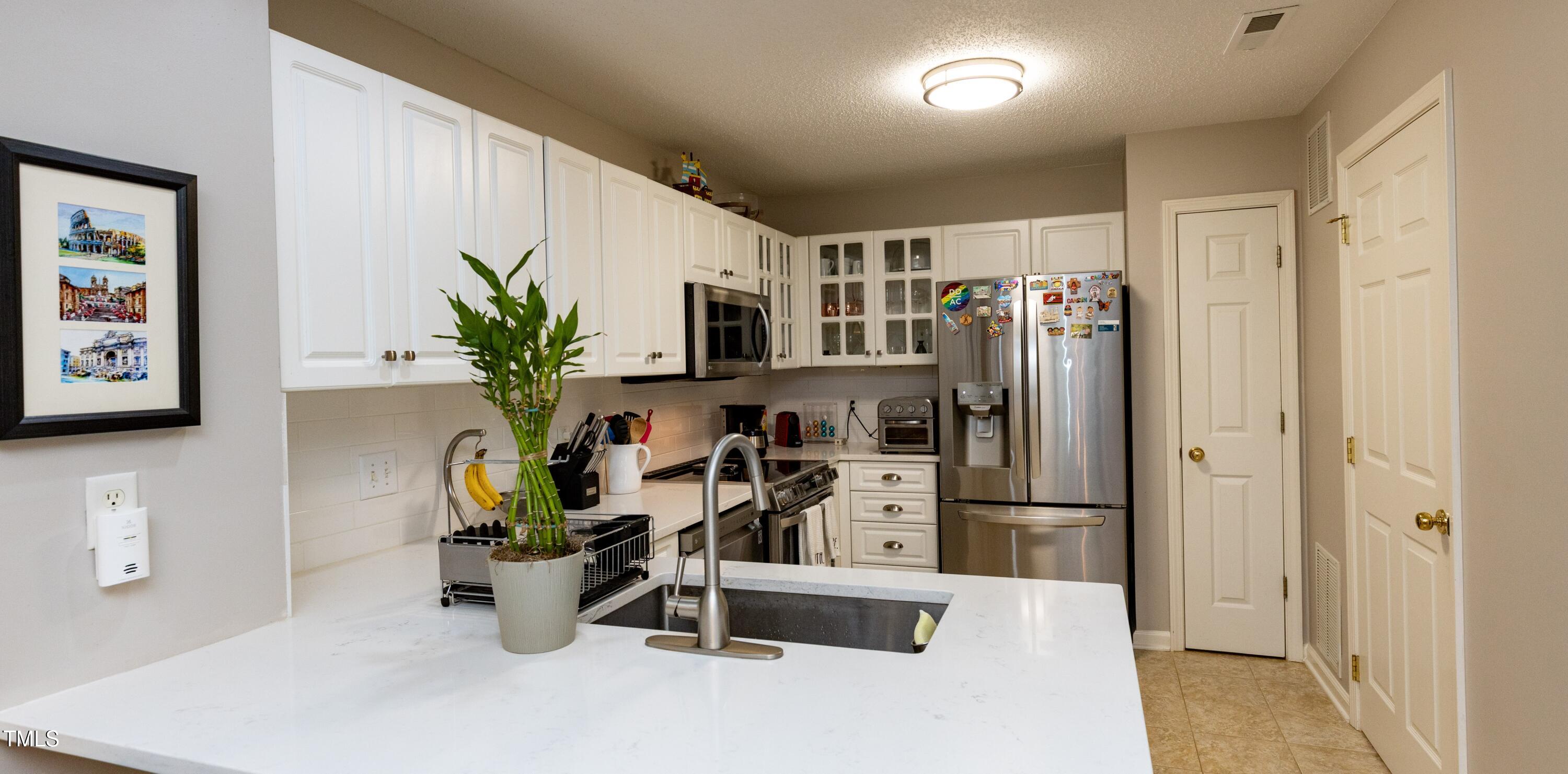 1911 Falls Landing Drive, Unit 103 Raleigh, NC 27614 - Photo 9 of 28 a dining room filled with furniture and a potted plant