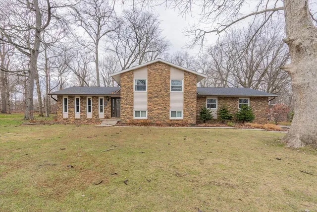 a view of house with yard