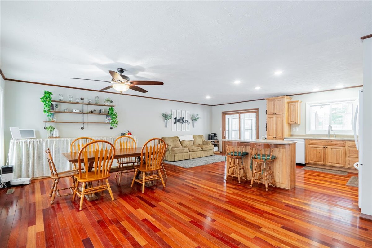 112 Gregory Lane Lexington, IL 61753 - Photo 11 of 39 a dining room with furniture wooden floor a rug and a painting
