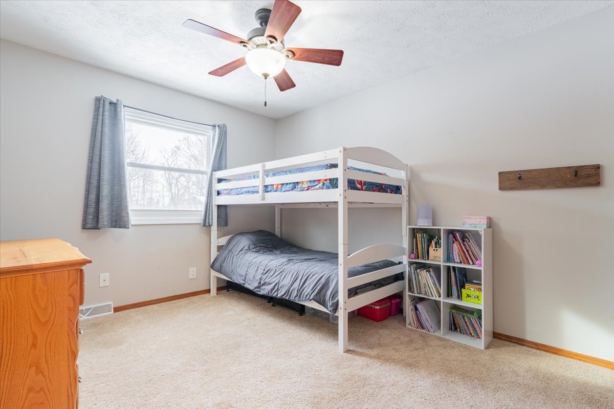 112 Gregory Lane Lexington, IL 61753 - Photo 23 of 39 a bedroom with a bed and a ceiling fan