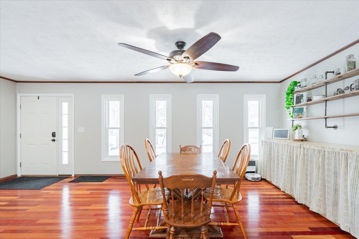 112 Gregory Lane Lexington, IL 61753 - Photo 10 of 39 a dining room with furniture a chandelier and wooden floor