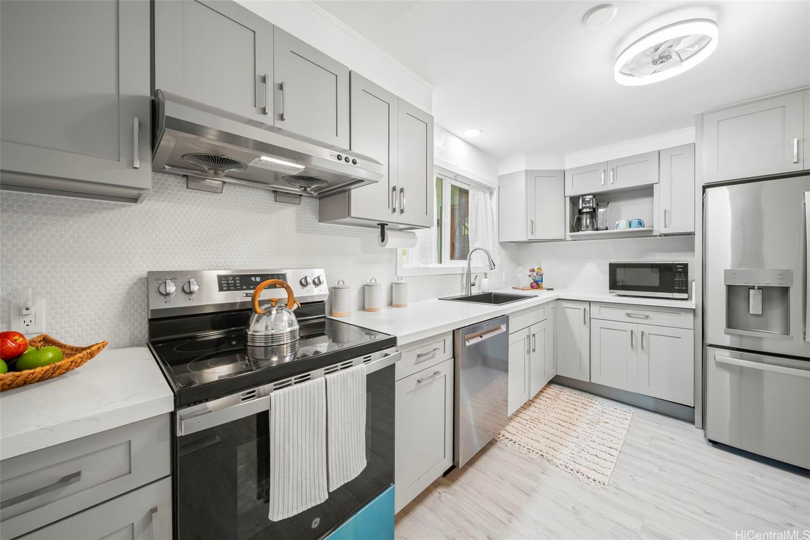 809 Hao Street Honolulu, HI 96821 - Photo 15 of 25 a kitchen with cabinets appliances a sink and a counter space