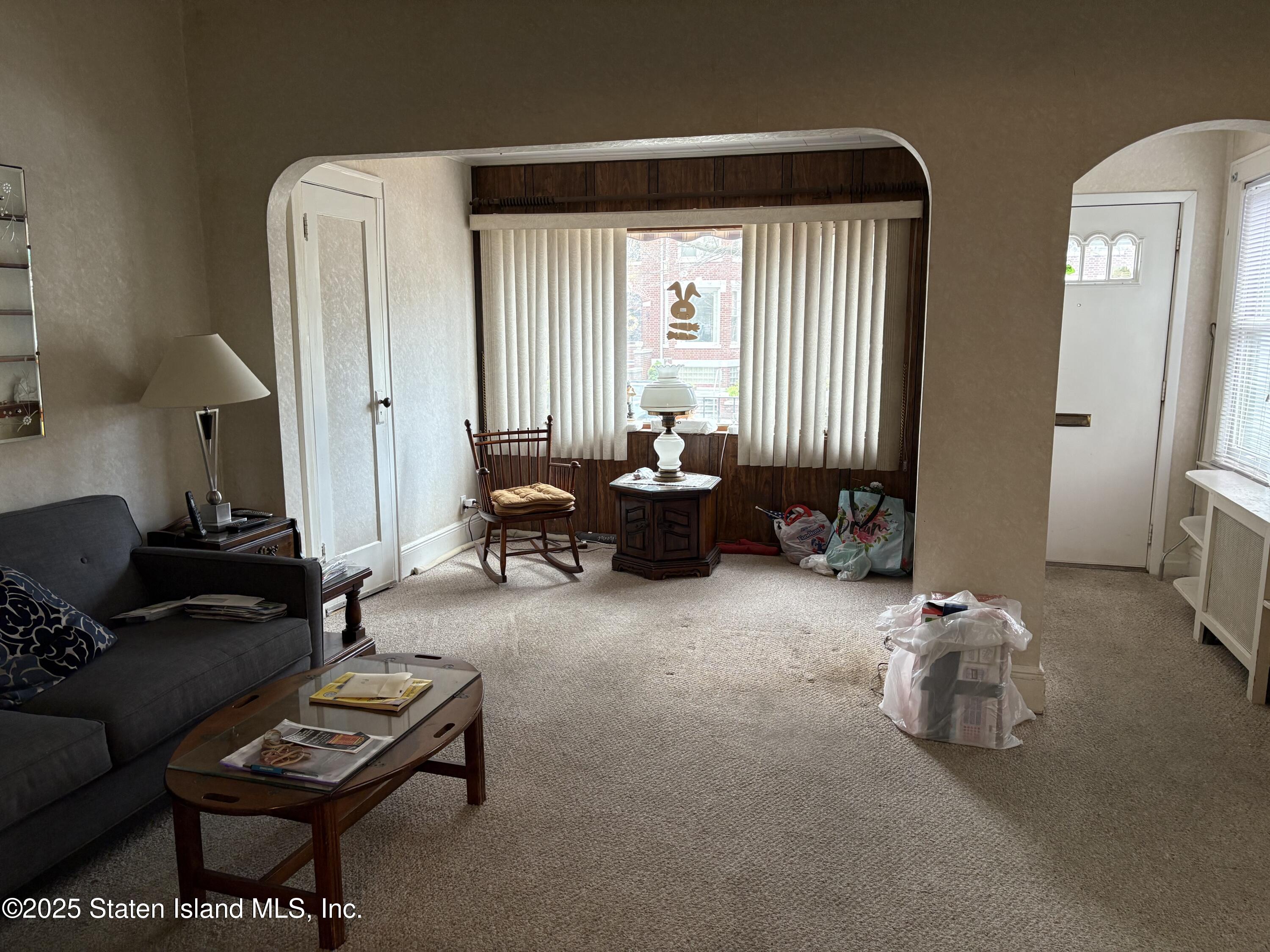 9105 Ridge Boulevard Brooklyn, NY 11209 - Photo 2 of 12 a living room with furniture and a window