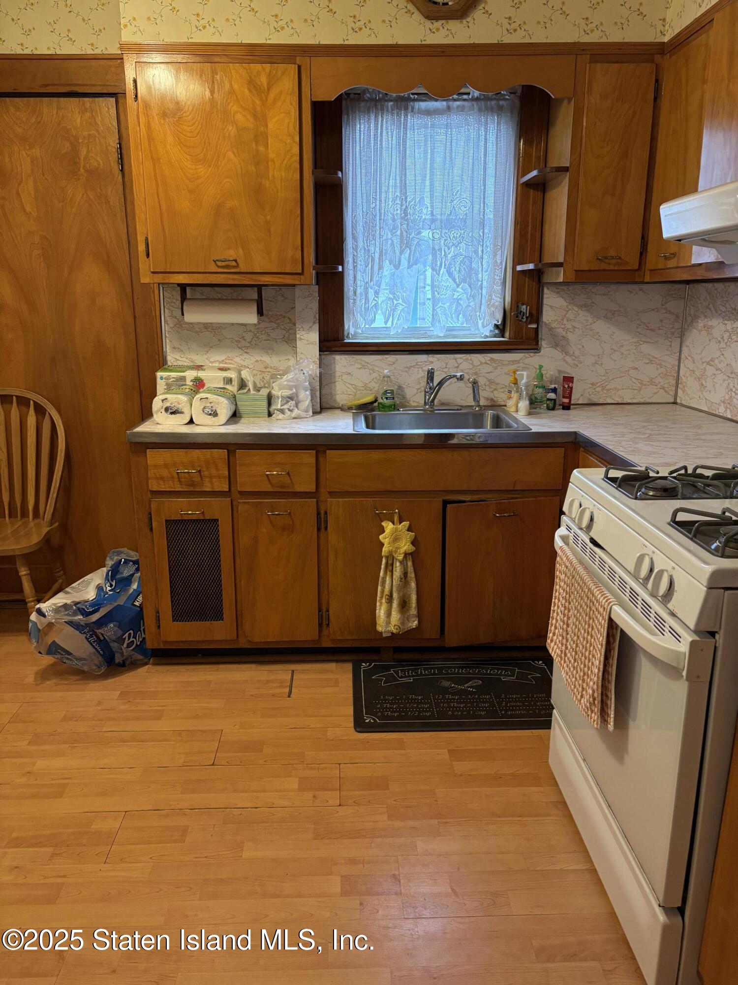 9105 Ridge Boulevard Brooklyn, NY 11209 - Photo 5 of 12 a kitchen with stainless steel appliances granite countertop a stove a sink and a microwave