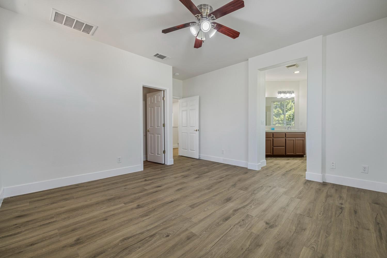 3105 Ripple Court Modesto, CA 95355 - Photo 25 of 46 a view of an empty room with wooden floor and a window
