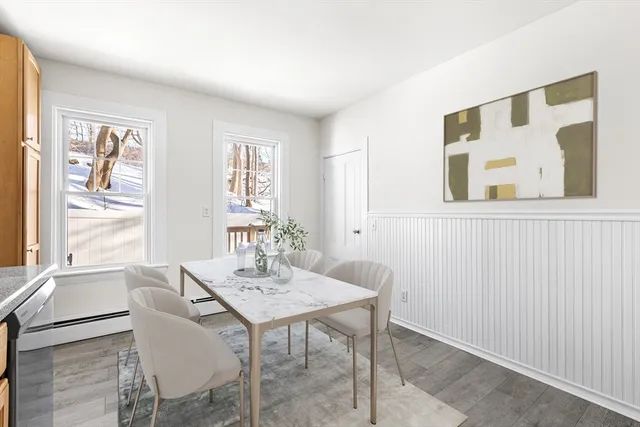 a view of a dining room with furniture and windows
