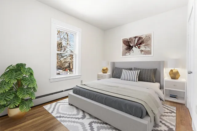 a bedroom with a large bed and a window