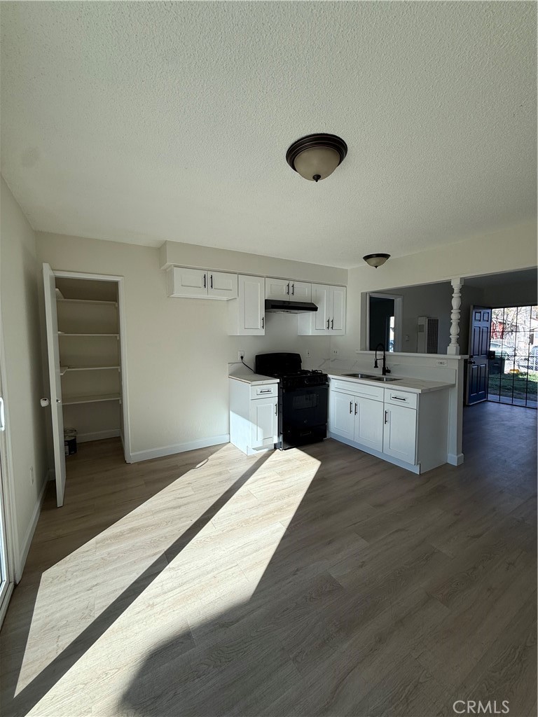 558 South Benjamin Street Rialto, CA 92376 - Photo 13 of 25 a large white kitchen with a stove a sink dishwasher and a refrigerator