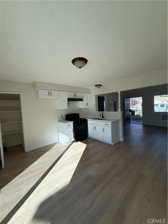 a kitchen with a cabinets and wooden floor