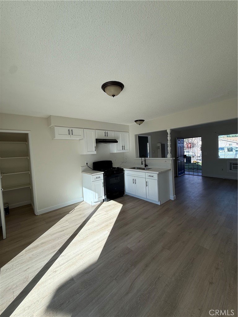 558 South Benjamin Street Rialto, CA 92376 - Photo 14 of 25 a kitchen with a cabinets and wooden floor