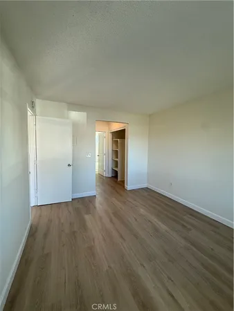 a view of an empty room and wooden floor