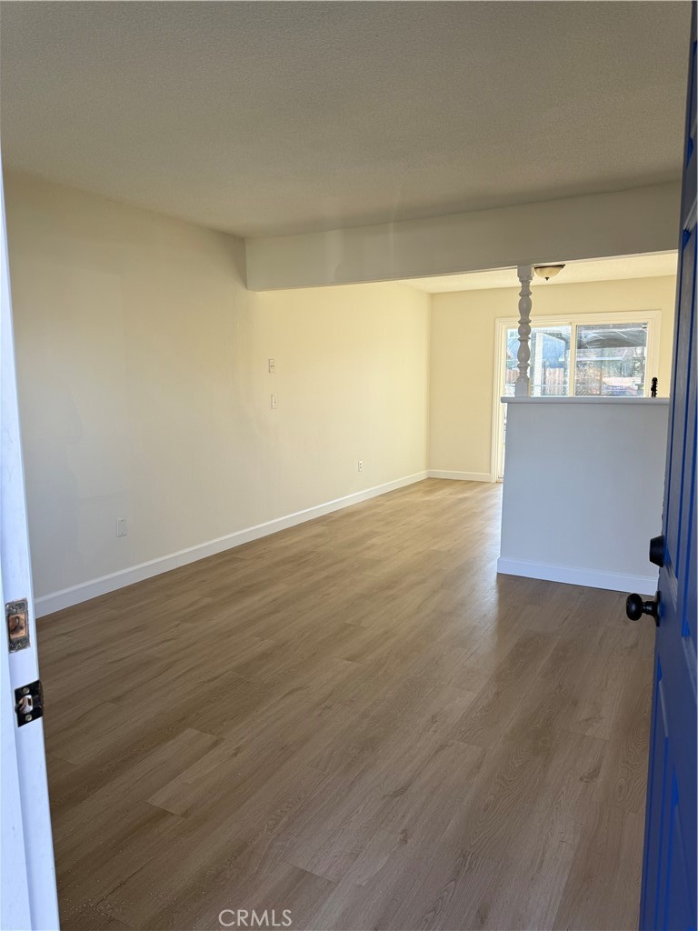 558 South Benjamin Street Rialto, CA 92376 - Photo 2 of 25 a view of a big room with wooden floor and windows