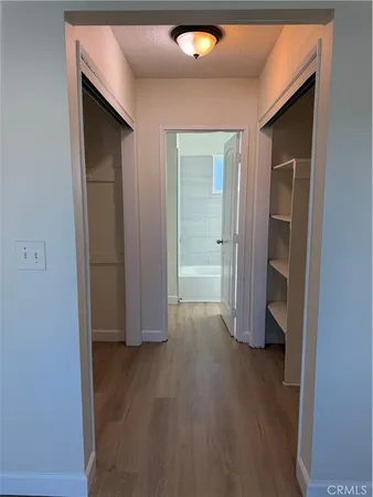 an empty room with wooden floor and closet