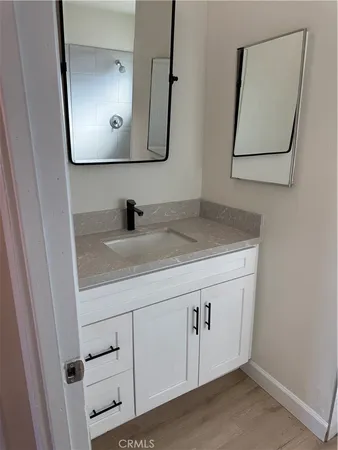 a bathroom with a sink vanity and mirror