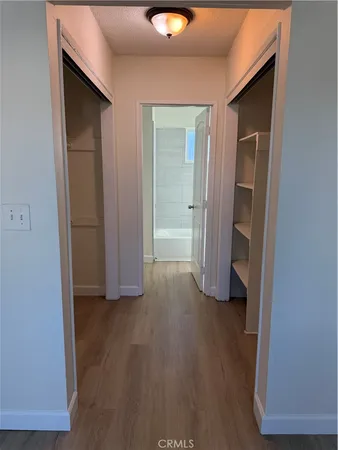 an empty room with wooden floor and closet