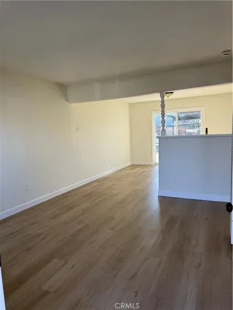 a view of a room with wooden floor