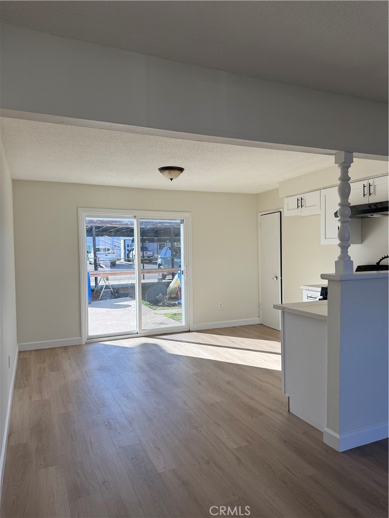 558 South Benjamin Street Rialto, CA 92376 - Photo 9 of 25 a view of empty room with wooden floor and window